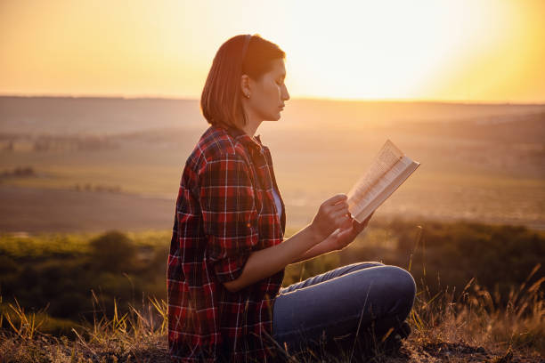 istock beautiful woman writing into her diary, in the park 1255586265