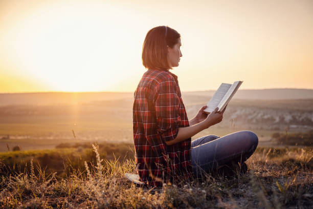istock beautiful woman writing into her diary, in the park 1255586277