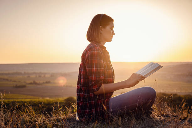 istock beautiful woman writing into her diary, in the park 1255586406
