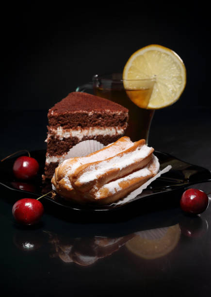 istock Cakes and a Cup of tea on a glossy table 1255587099