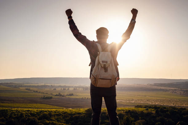 istock Silhouette of a champion on mountain peak. Active life concept 1255587206