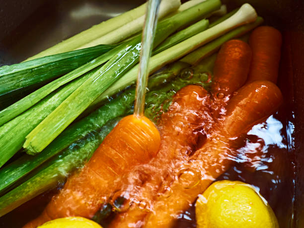 Fresh carrot, leek and lemon in water.