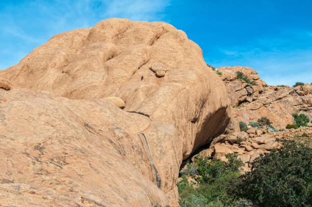 istock Tourist is visible on rocks above cave at Bushmans Paradise 1255588226