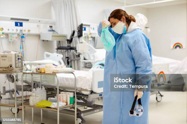 One Female Doctor Tired And Overworked At The Icu Stock Photo - Download Image Now - Emotional Stress, Doctor, Coronavirus