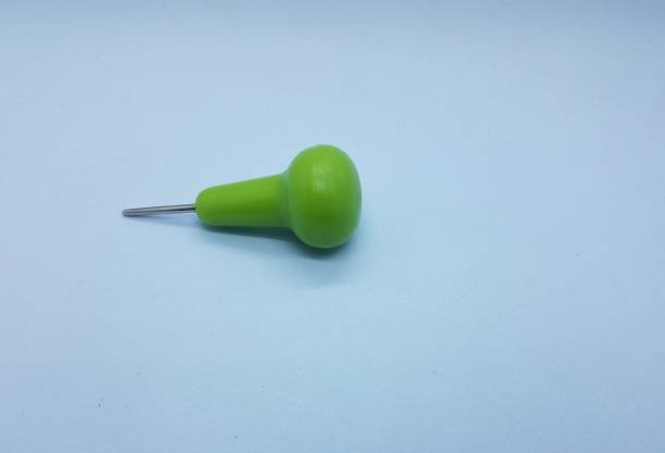 istock green braille metal stylus on white background 1255589604