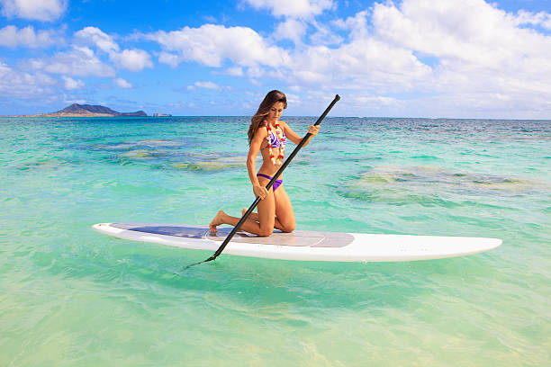 istock girl in bikini on her stand up paddle board 125558974
