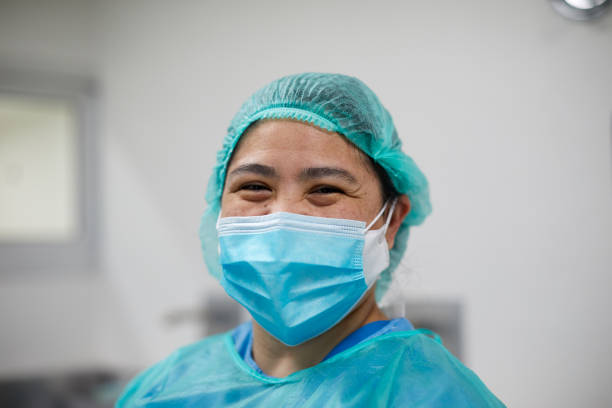 Nurse proudly smiling at camera at the hospital. Nurse proudly smiling at camera at the hospital. filipino ethnicity photos stock pictures, royalty-free photos & images