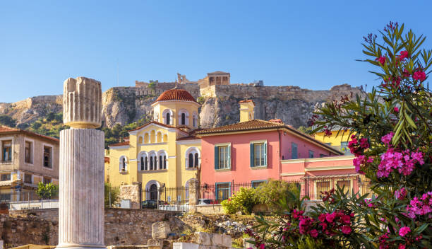 Old houses in Athens, famous Acropolis in distance, Greece. Beautiful scenic view of Plaka district in Athens city center Old houses in Athens, famous Acropolis in distance, Greece. Beautiful scenic view of Plaka district in Athens city center, urban landscape in summer. This place is tourist attraction of Athens. plaka athens stock pictures, royalty-free photos & images
