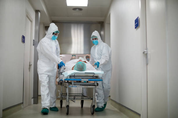 Transferring a patient from the emergency area into the ICU Transferring a patient from the emergency area into the ICU intensive care unit stock pictures, royalty-free photos & images
