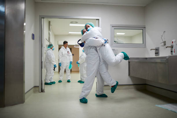 istock Two doctors hug in celebration of a successful surgery procedure 1255592019
