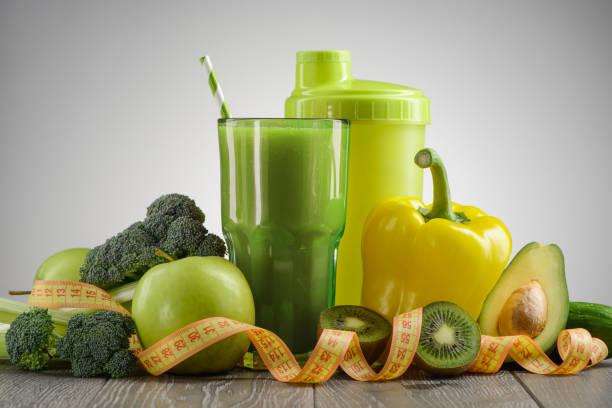 Green fruits and vegetables on gray background