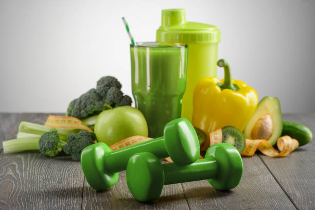 istock Pair of green dumbbells in the foreground 1255592958
