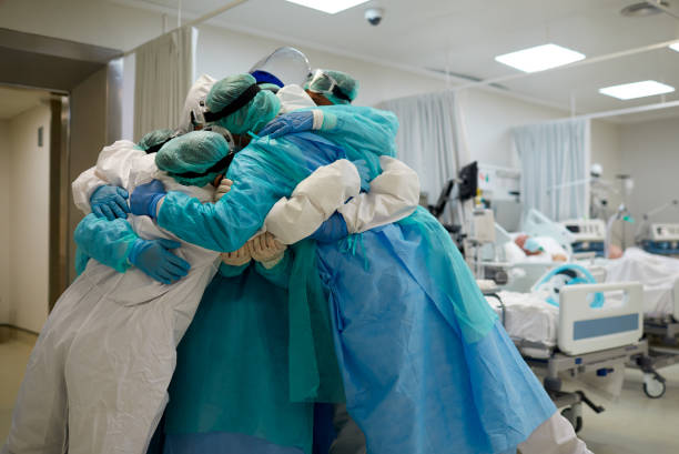 istock Healthcare workers hug and cuddle together at ICU 1255593169