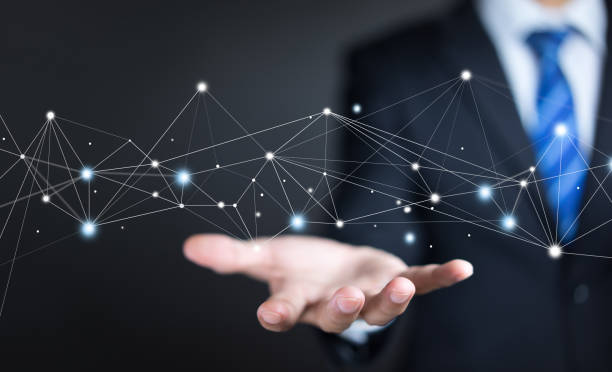 istock Businessman on background holding connections system and global datas exchanges. Business network connection concept. 1255593259