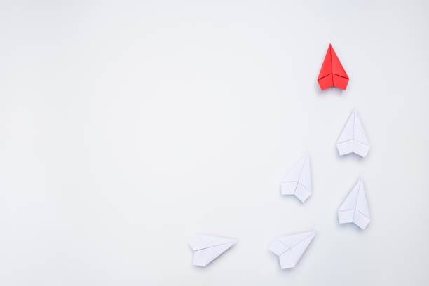 Leadership concept with red paper plane leading, copy space stock photo