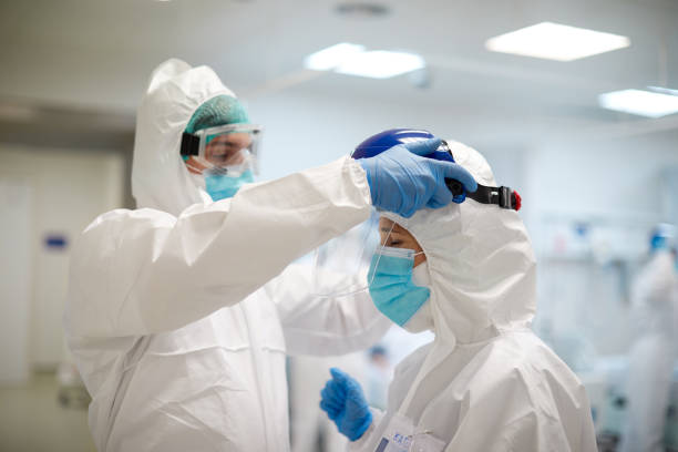istock An expertise doctor supervises that protective clothes are put on correctly. 1255594291