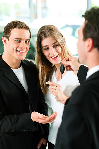 istock Car sales - key being given to couple 125559554