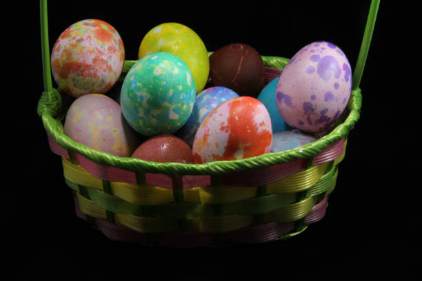 istock Variety of Colored Eggs in a Basket 1255597516