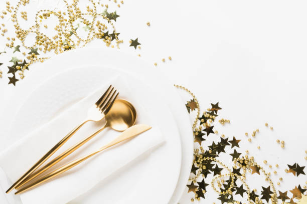 istock Golden table setting with shiny stars and beads on white. 1255597596