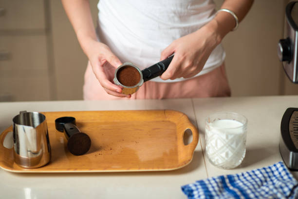 istock Woman making coffee drink in the kitchen at home 1255599360