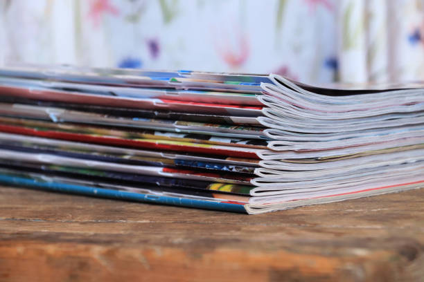 istock Old magazines on wooden table 1255599586