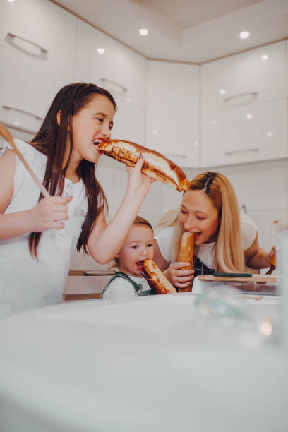 istock Playful mom and little daughters have fun baking at home 1255601015