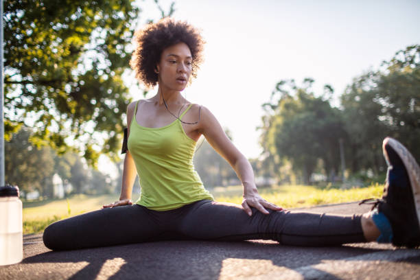 istock Young woman stretching body after jogging 1255602751