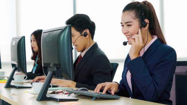 istock Business people wearing headset working in office 1255605827