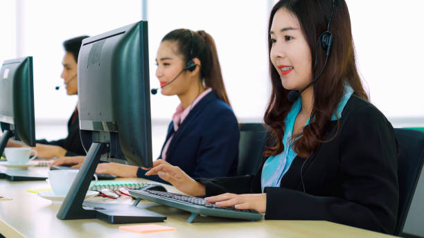 istock Business people wearing headset working in office 1255607295