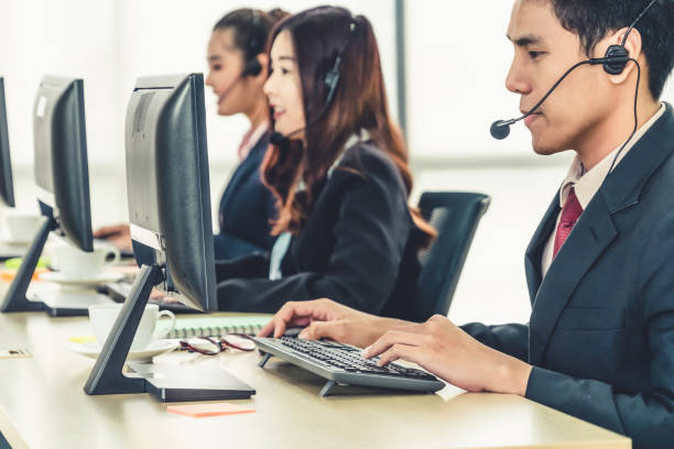 istock Business people wearing headset working in office 1255607976