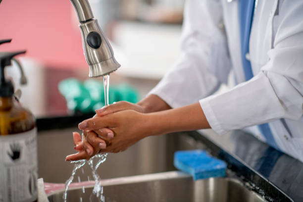 istock Female doctor washing hands 1255608915