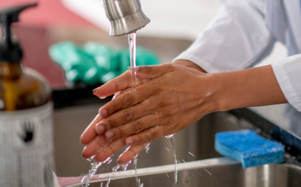 istock Female doctor washing hands 1255608917