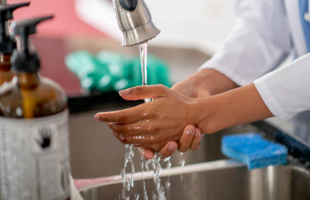 istock Female doctor washing hands 1255608924