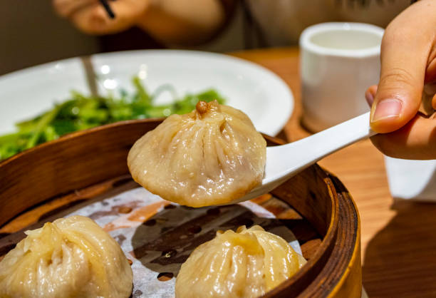 istock Chinese soup dumplings (Tang Bao) in bamboo steamer 1255609137