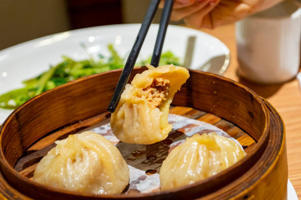 istock Chinese soup dumplings (Tang Bao) in bamboo steamer 1255609141