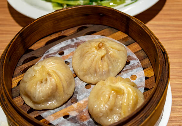 istock Chinese soup dumplings (Tang Bao) in bamboo steamer 1255609471