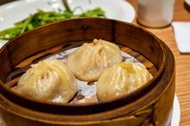 istock Chinese soup dumplings (Tang Bao) in bamboo steamer 1255610062