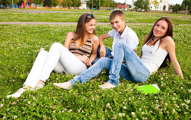 small group of students in a clearing on meadow stock photo