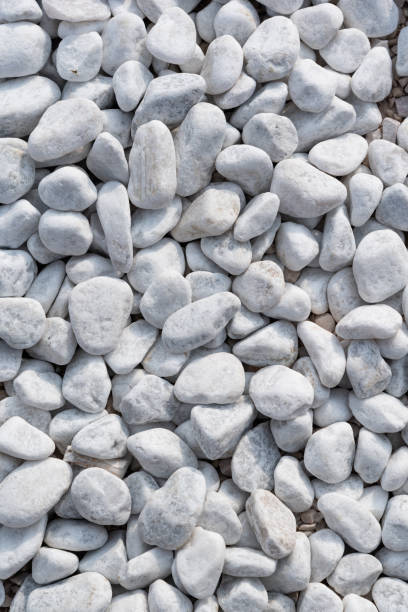 istock Small white stones on the ground on a close up shot 1255610351