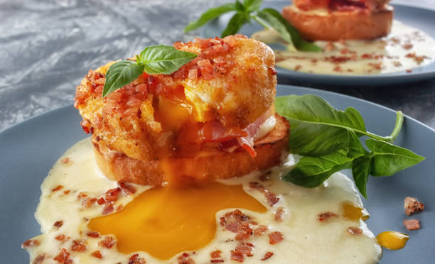 istock Eggs Benedict on toasted muffins with ham and sauce 1255611901
