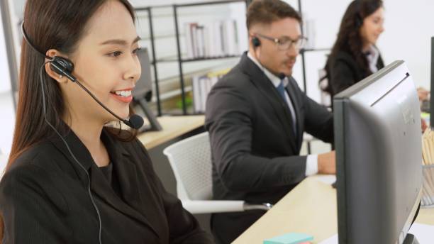 istock Business people wearing headset working in office 1255612274