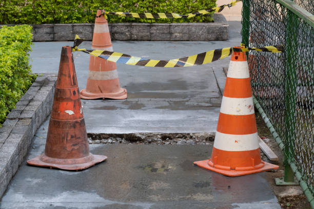 istock Hole marked with cones and safety strip. 1255615190