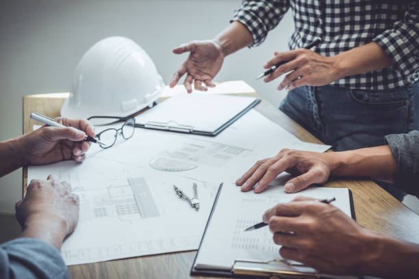 istock Construction and structure concept of Engineer or architect meeting for project working with partner and engineering tools on model building and blueprint in working site, contract for both companies 1255616422