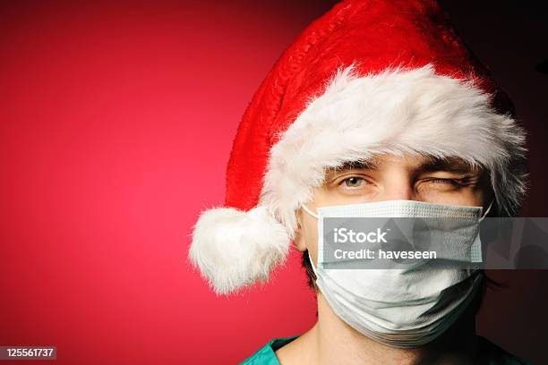 Man Wearing A Facemask And Christmas Hat Stock Photo - Download Image Now - Adult, Adults Only, Christmas