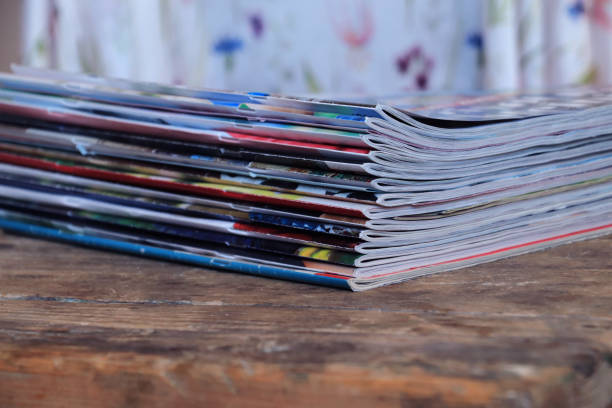 istock Old magazines on wooden table 1255618165