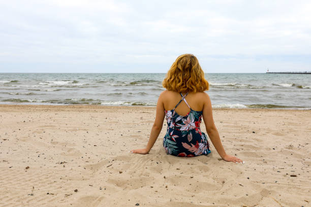 istock Beautiful woman relaxing on the beach 1255621206