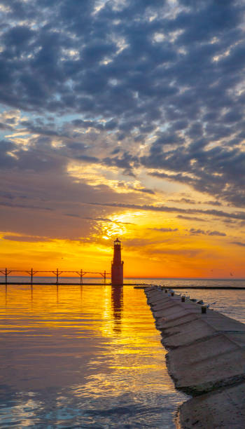 istock Amazing down sky over tranquil harbor with lighthouse. 1255623266