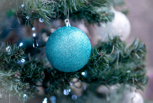 istock blue ball on a Christmas tree with blue lights 1255623313