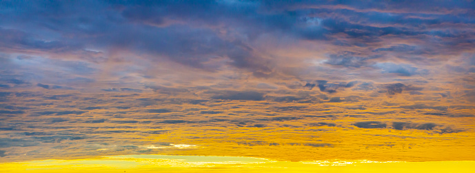 Vast panoramic dawn sky background with amazing clouds.