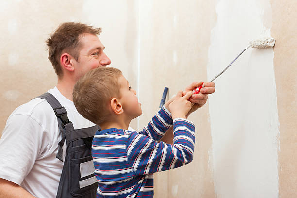 istock Father painting wall with child 125562405